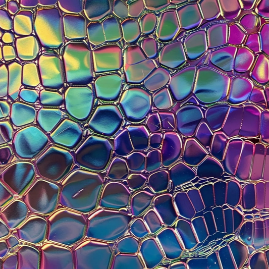 A close-up image of a multicolored, holographic faux crocodile patterned waterproof fabric.